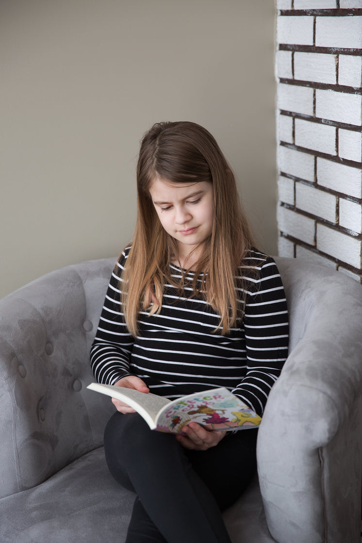 a-girl-sitting-in-a-chair-reads-a-book.jpg?width=746&format=pjpg&exif=0&iptc=0