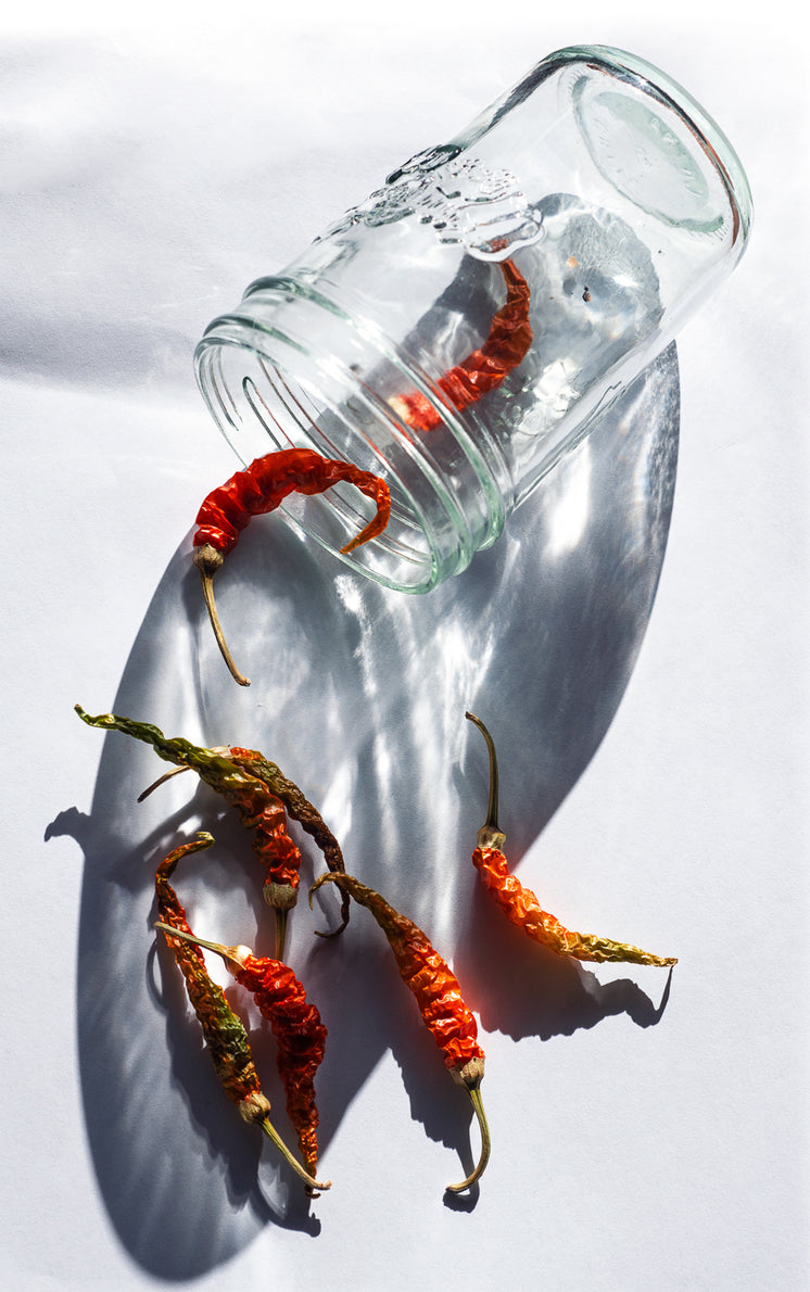a-glass-jar-with-red-chili-peppers-falling-out-of-it.jpg?width=746&format=pjpg&exif=0&iptc=0