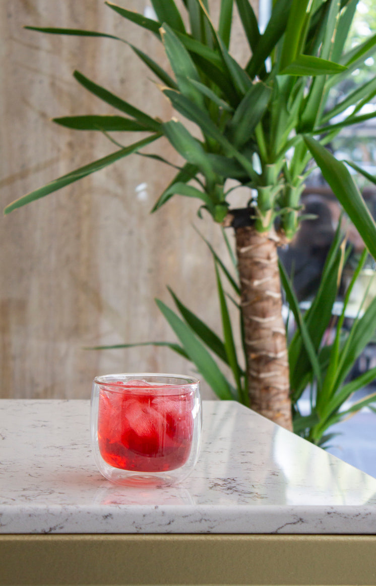 A Glass Tumbler Of Juice On A Marble Counter