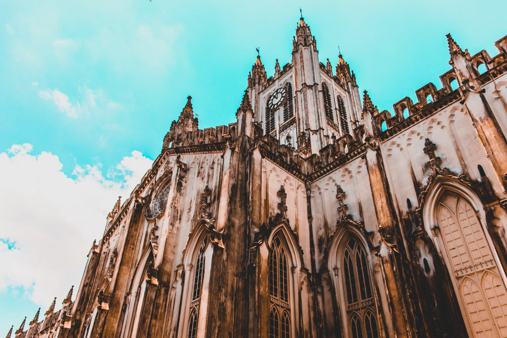 a gothic church points to the blue sky