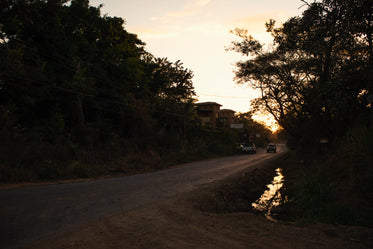 a gravel road at sunset