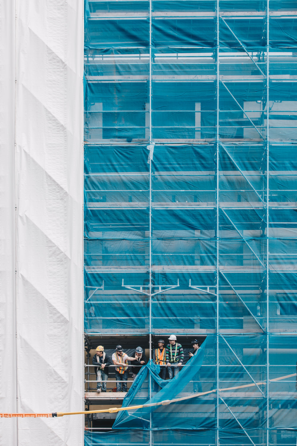 a group of builders on scaffolding