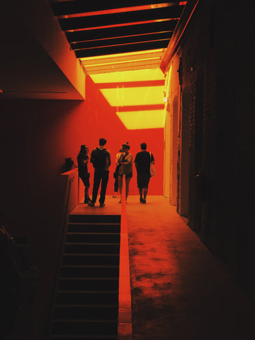 a group of people stand surrounded by a red glow