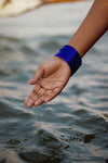 a hand cupped over wavy water