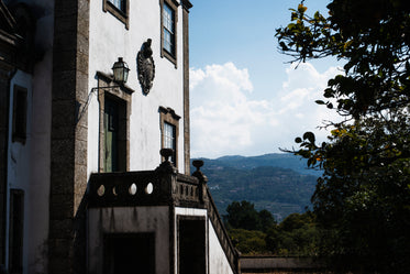 a historical building in the shadows of neighboring trees