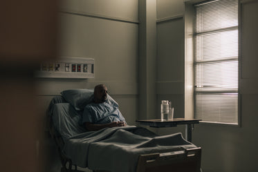 a hospital patient sat in bed with his hands crossed