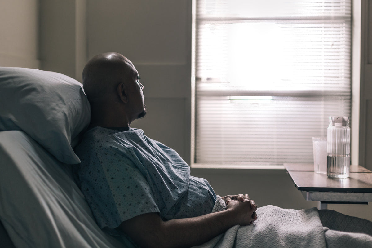 a hospital patient stares out window of room