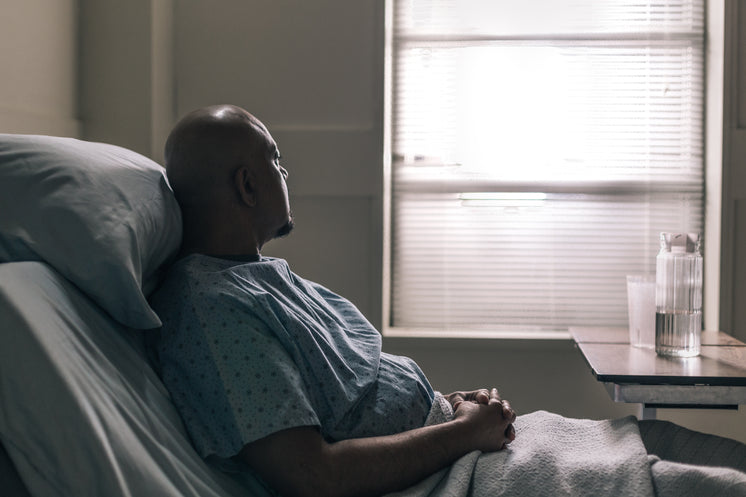 A Hospital Patient Stares Out Window Of Room