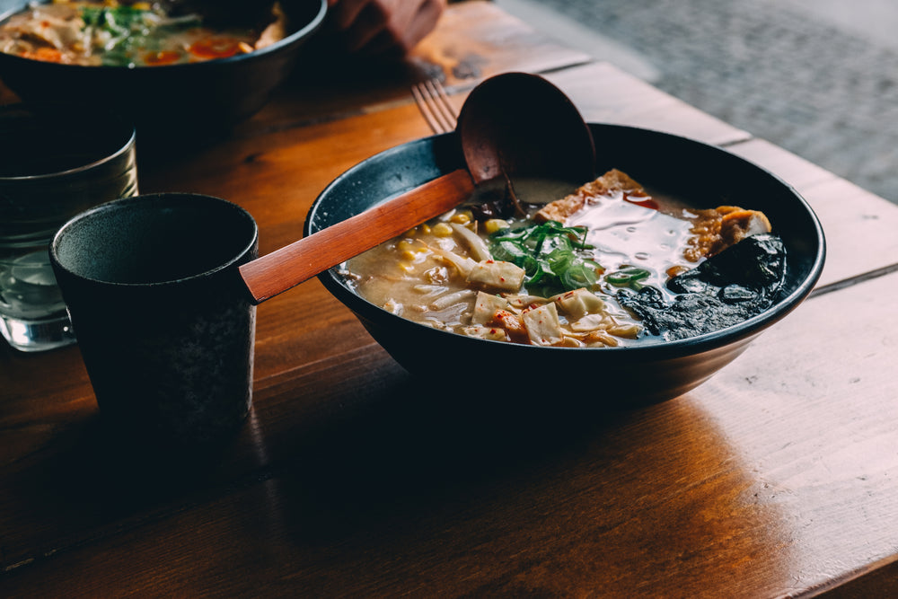 a hot bowl of soup on a table top