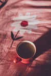 a hot cup of tea in bed