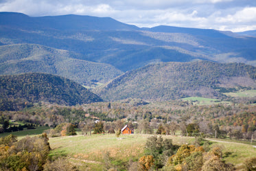 a house nestles in the mountainous woodland landscape