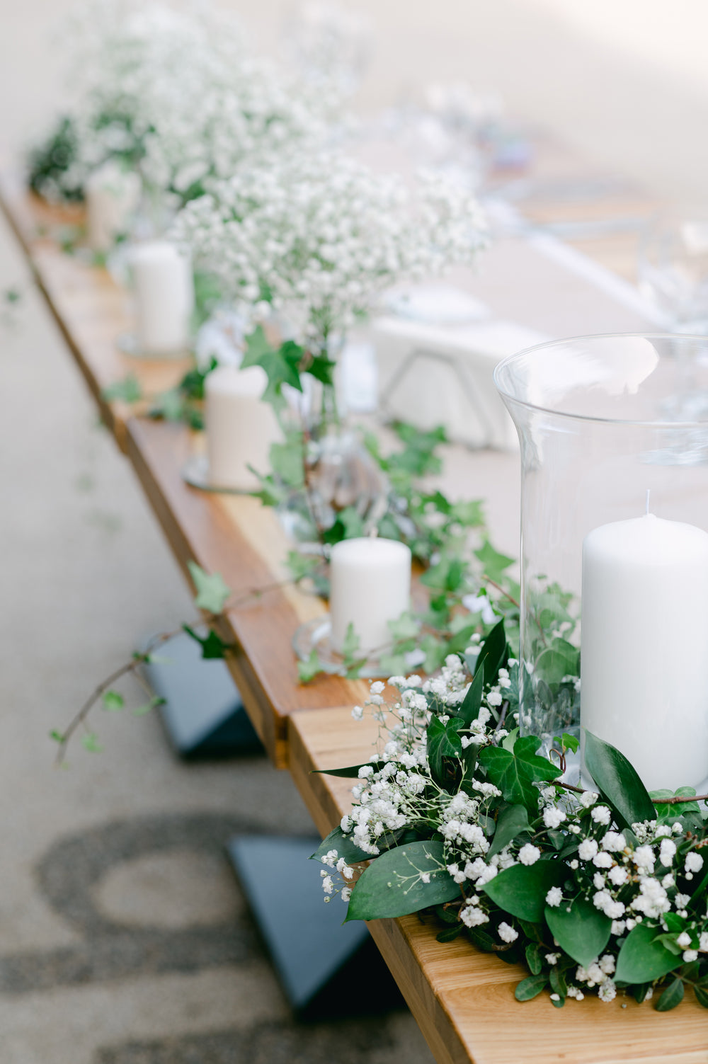 a line of white candle table centerpieces