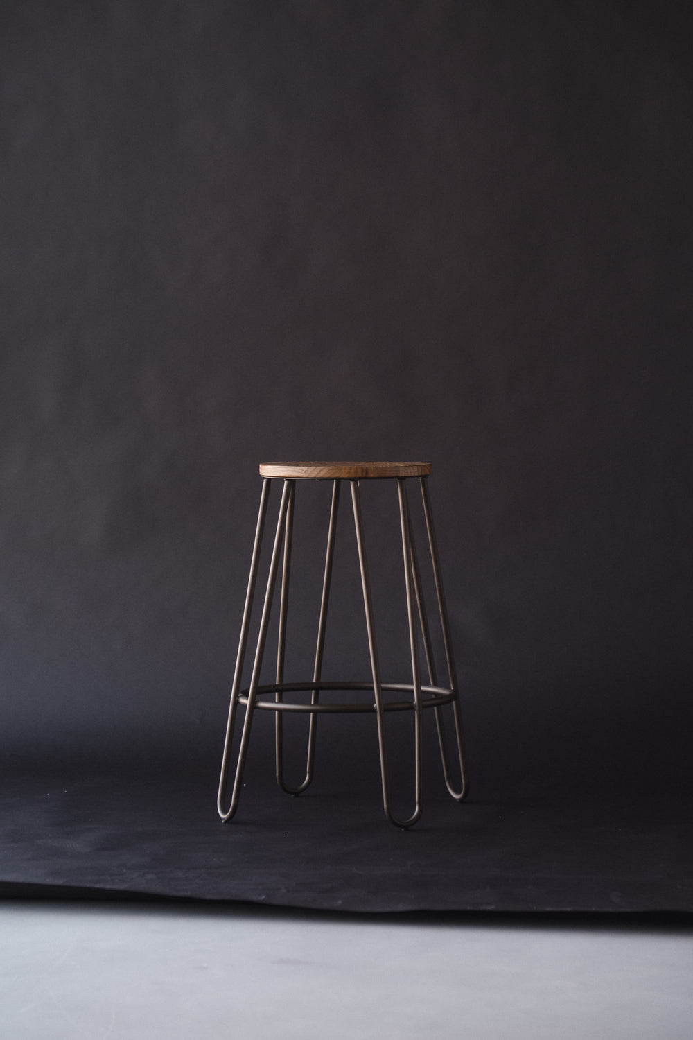 a lonely stool on a backdrop