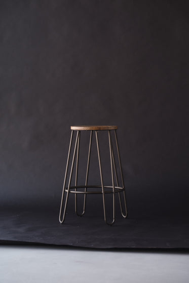 a lonely stool on a backdrop