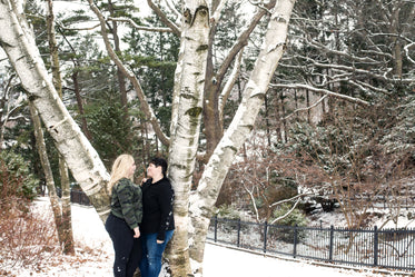 a loving look while stood by a tall tree