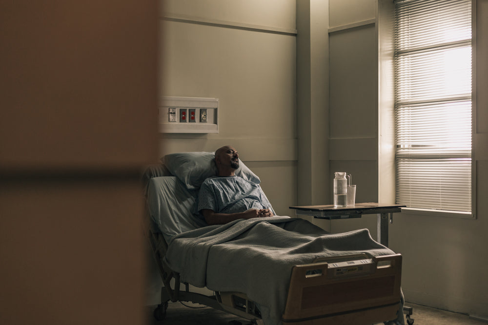 a male patient lying in hospital bed