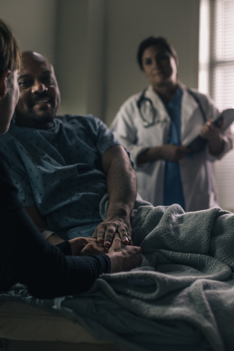 a-male-patient-smiles-while-holding-the-