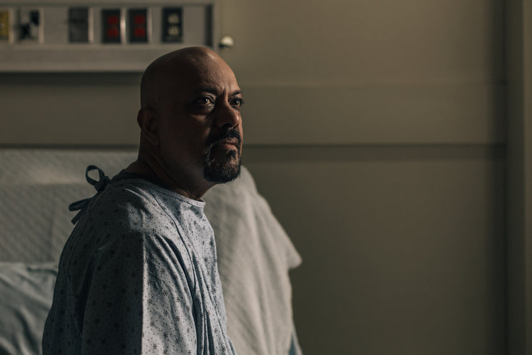 A Man In A Gown In A Hospital Room