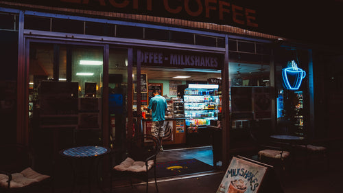 a man stands at the counter of a coffee shop