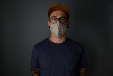a man stands wearing a face mask