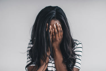 a model covers her face with her hands