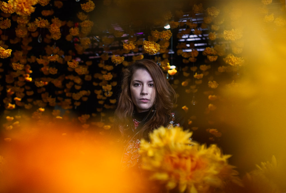 a model framed by her world of yellow flowers