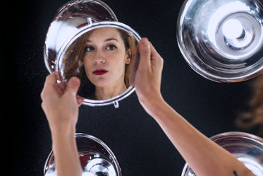 a model gazes into her makeup mirror