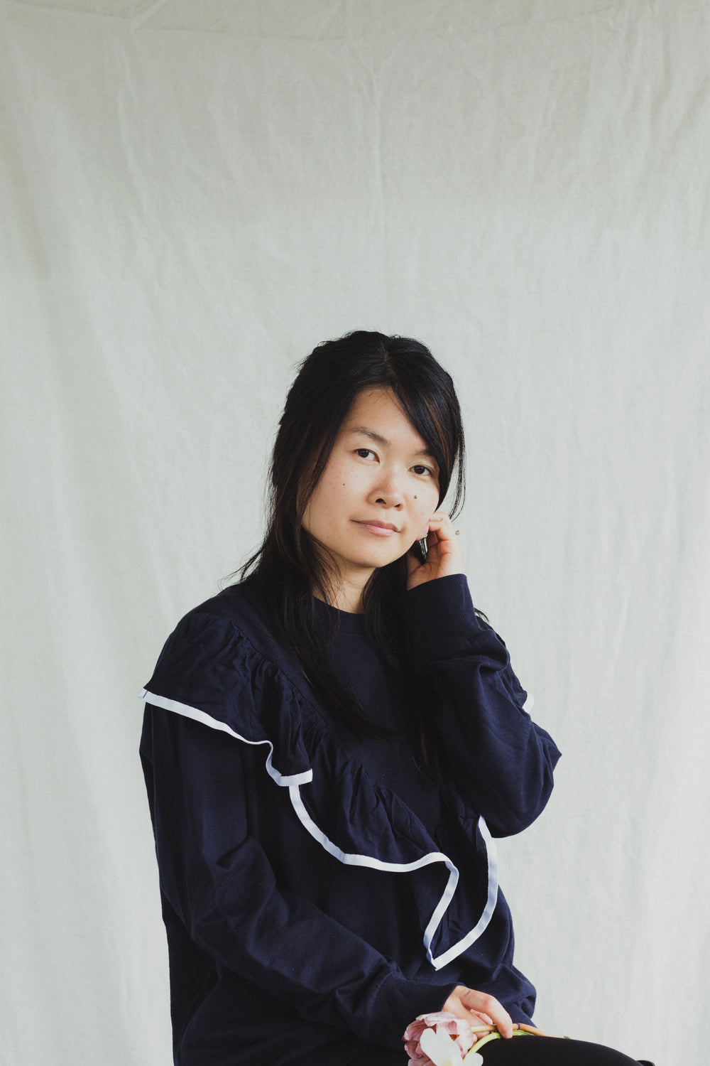 a model in a blue sweater with flowers