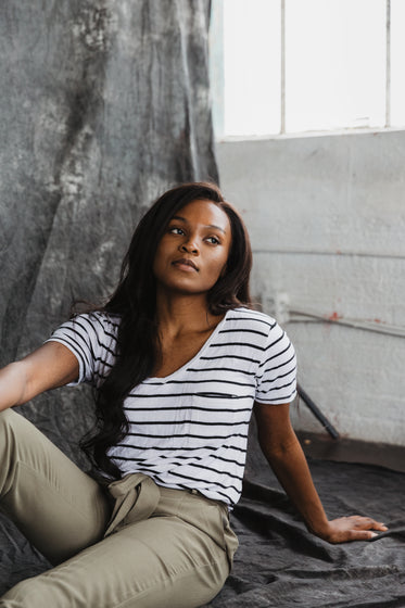 a model in khaki trousers and a striped t-shirt