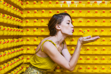 a model kisses rubber ducks in search of her prince charming