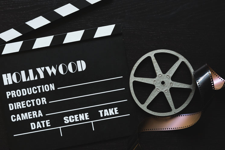 A Movie Clapper Board, Film Roll And Sprocket Wheel