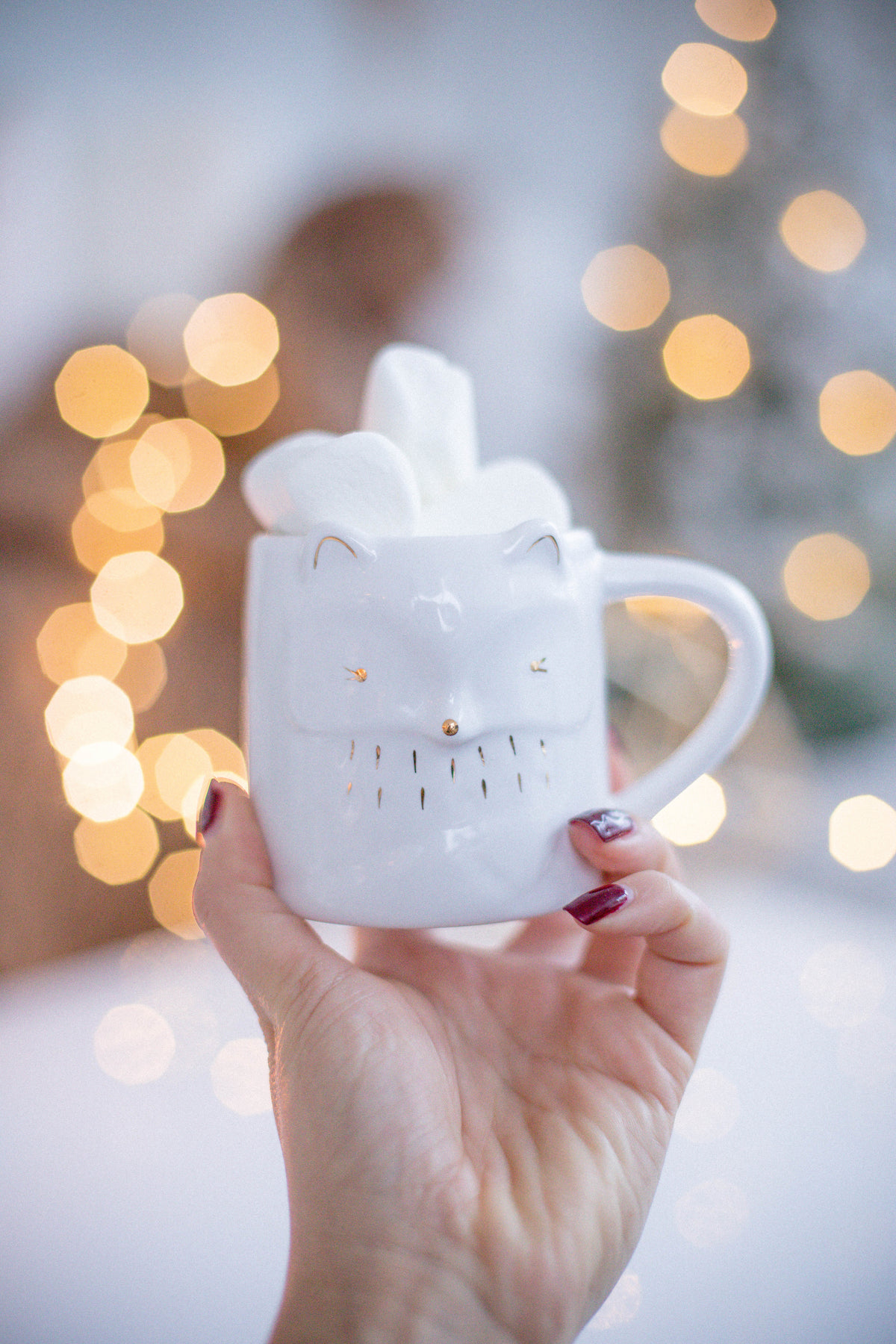 a mug with the face of a fox is full of marshmallows