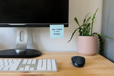 a note on a computer monitor with a positive message