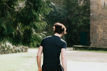 a person in black shirt walks away from frame