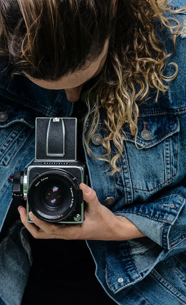 a person looking into the viewfinder of hasselblad camera