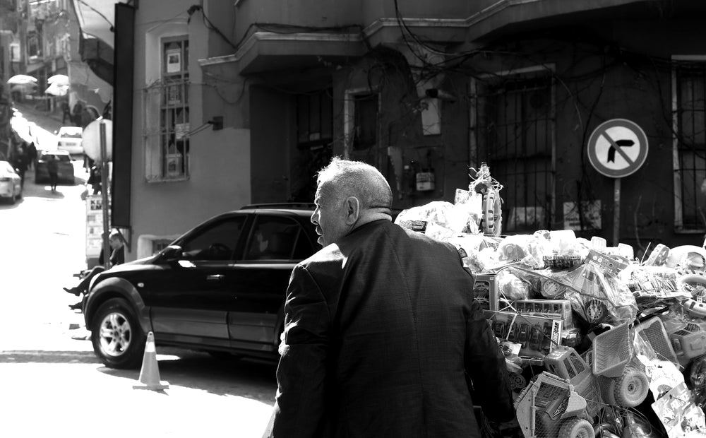 a person looking to cross the street in black and white