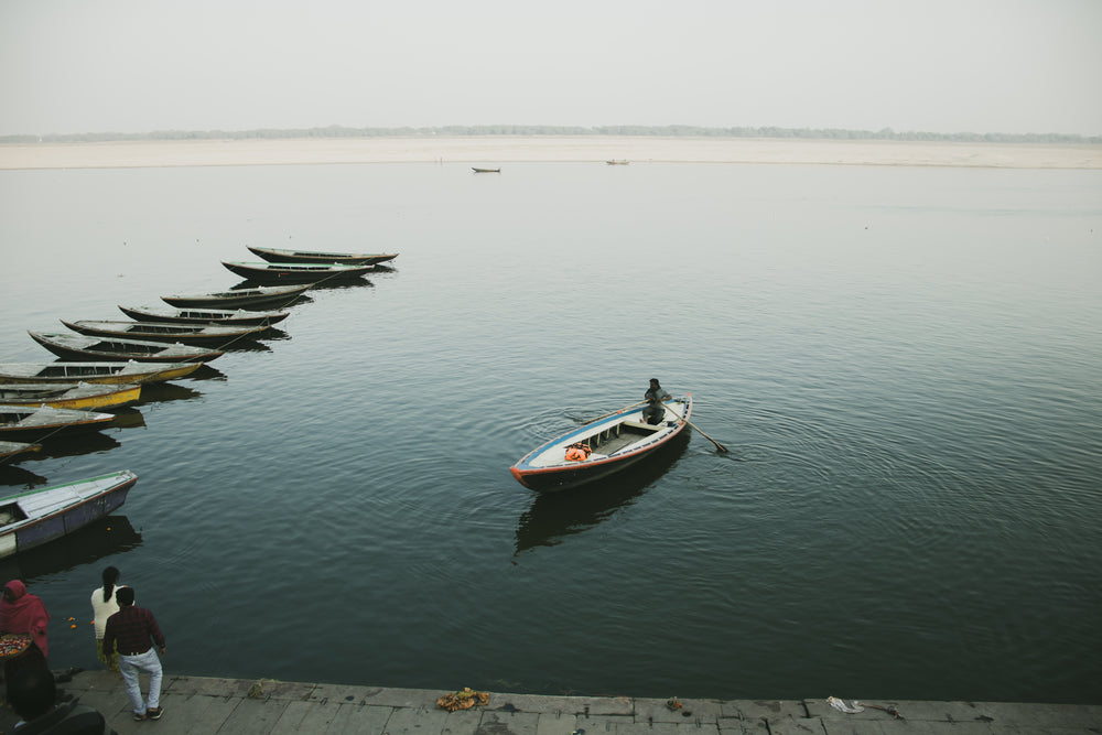 a person rowing their boat to shore at night