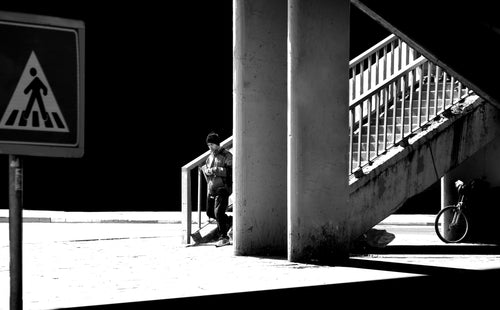 a person walking down a city stairwell in monochrome