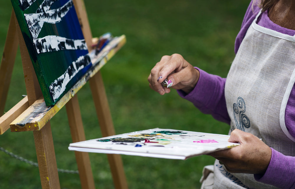 a person with a pallet knife and pallet in their hands