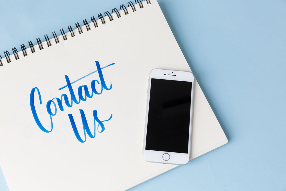 a phone on a blue background with 'contact us'