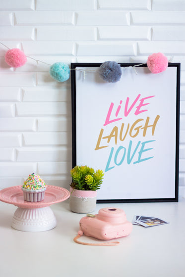 a picture reads "live laugh love" joined by random objects