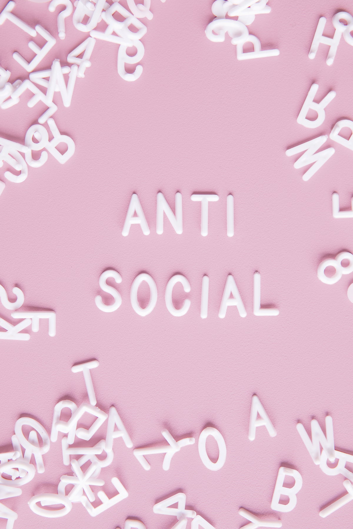 a pink and white letter board spells out "anti-social"