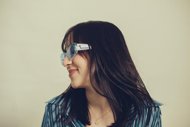 a profile of a woman in blue tinted sunglasses