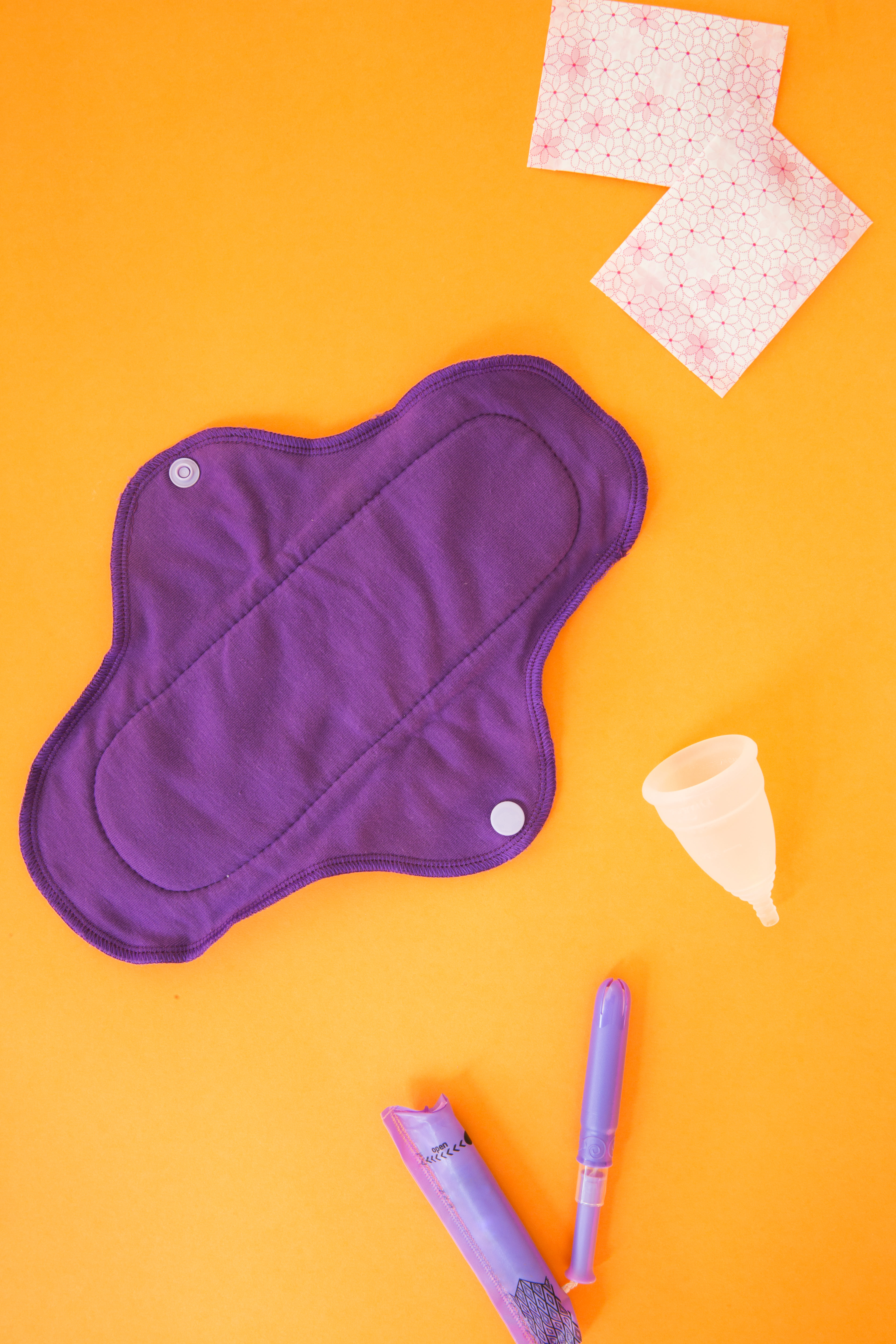 A Purple Reusable Menstrual Pad, Cup And Applicator