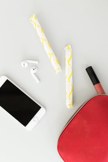 a red purse spills feminine products onto a table