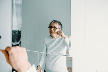 a reflection of a person brushing their teeth