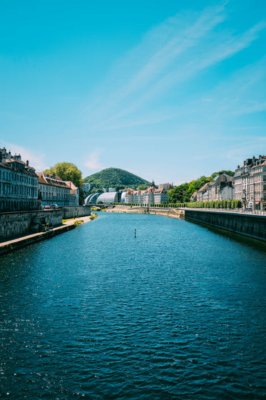 a river curves down from mountains to cut through a town