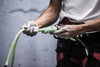 a rock climber holds out knotted rope