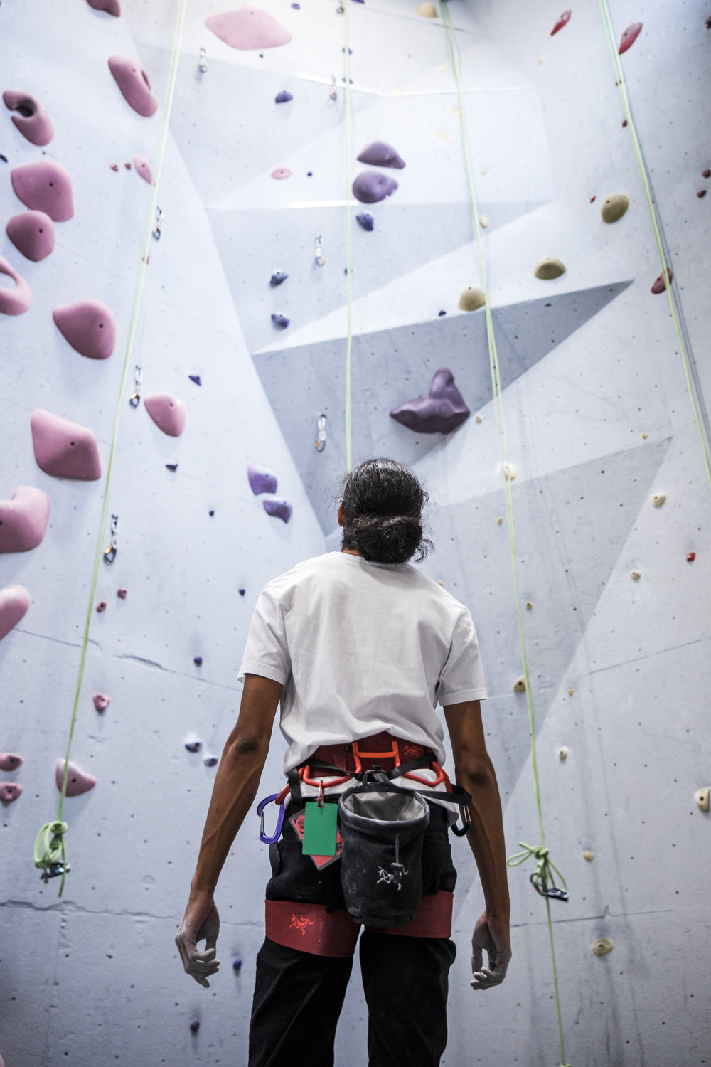 a rock climber takes in the sight of his next climb