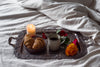 a romantic candle lit breakfast on a silver tray